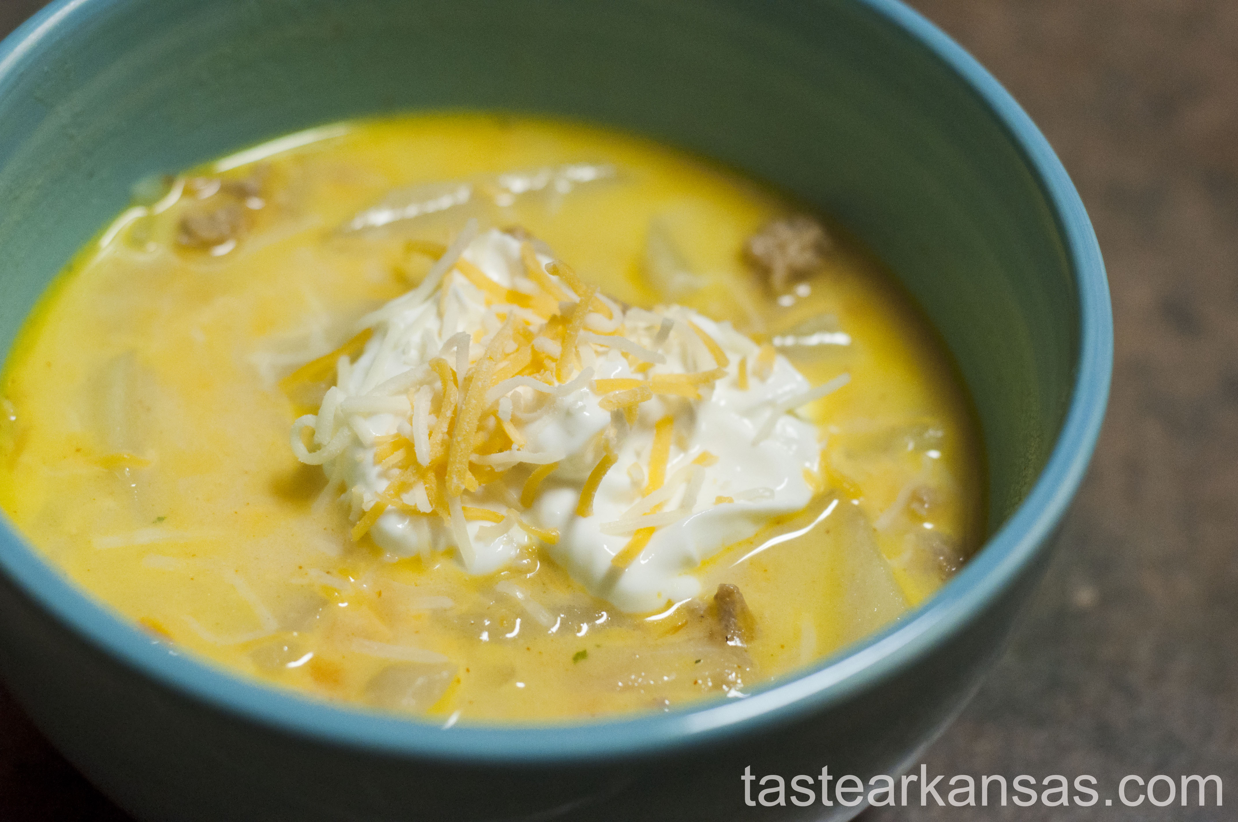 this picture is of a warm steamy bowl of turkey cheeseburger soup