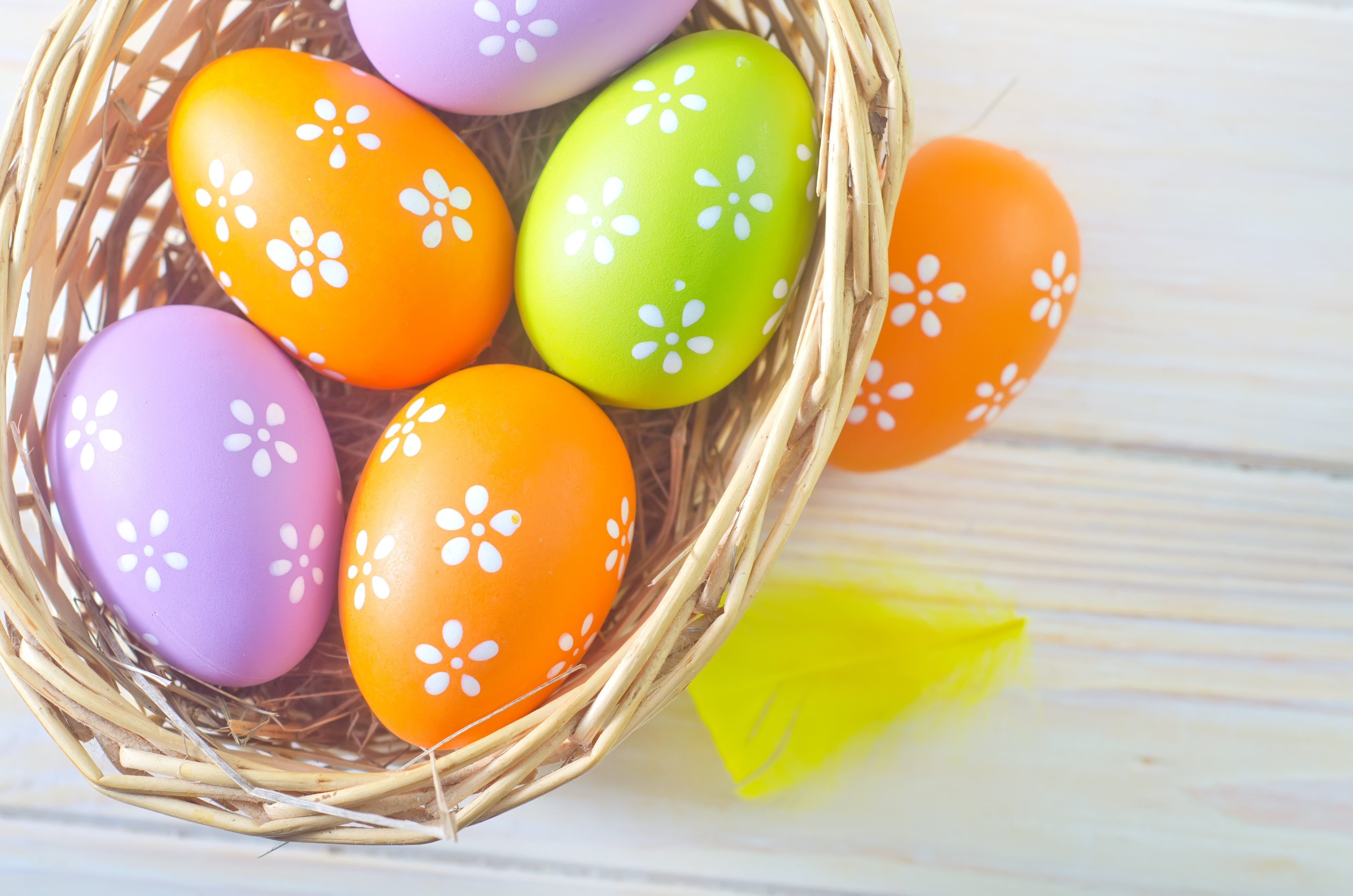 this photo is of a basket of colorfully decorated Easter eggs